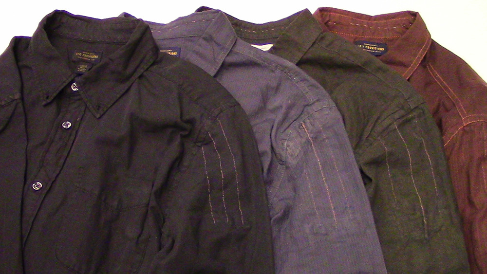The Ripple garments are shown with four of the shirts laid overlapping on a flat surface. The garments themselves are dark brown, purple, light brown, and brownish red from left to right.